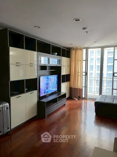 Spacious living room with modern entertainment center and large windows