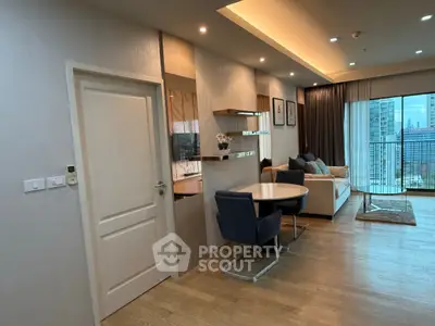 Modern living room with elegant decor and city view balcony