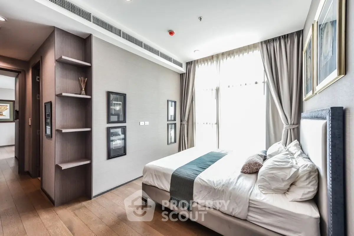 Luxurious bedroom with elegant decor and large window offering natural light