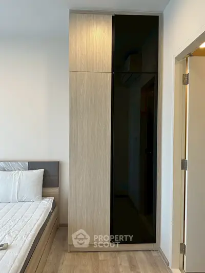 Modern bedroom with sleek wardrobe and cozy bed in stylish apartment