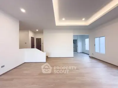 Spacious modern living room with wooden flooring and recessed lighting