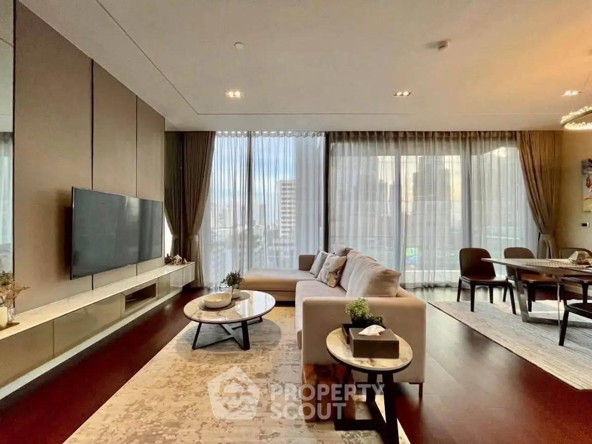 Luxurious modern living room with elegant decor and city view, featuring spacious seating and dining area.