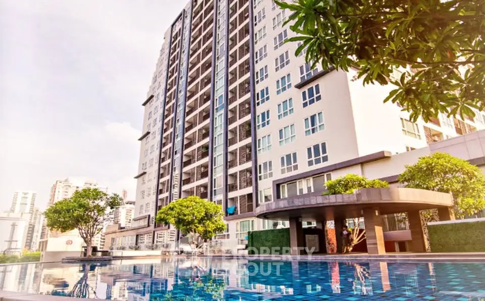 Luxurious high-rise building with stunning pool and lush greenery, perfect for modern urban living.