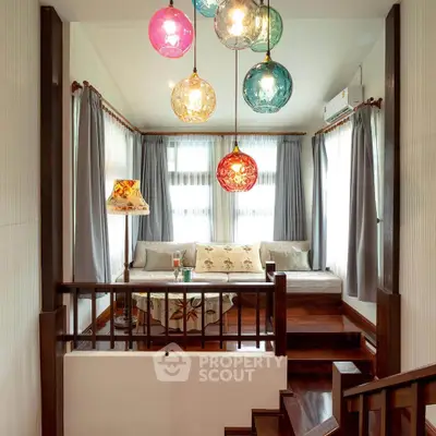 Charming living room with colorful pendant lights and cozy seating area