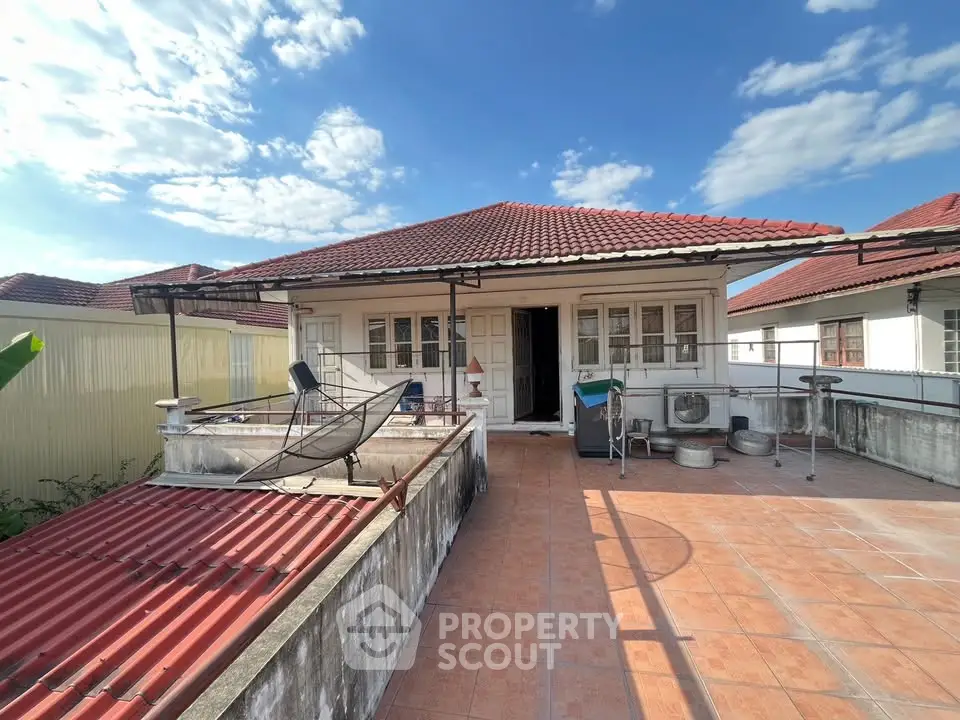 Charming rooftop terrace with red tile roof and open sky view
