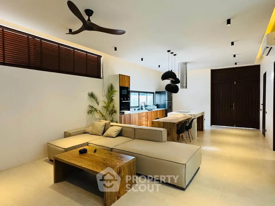 Modern open-plan living room with sleek kitchen and stylish furniture
