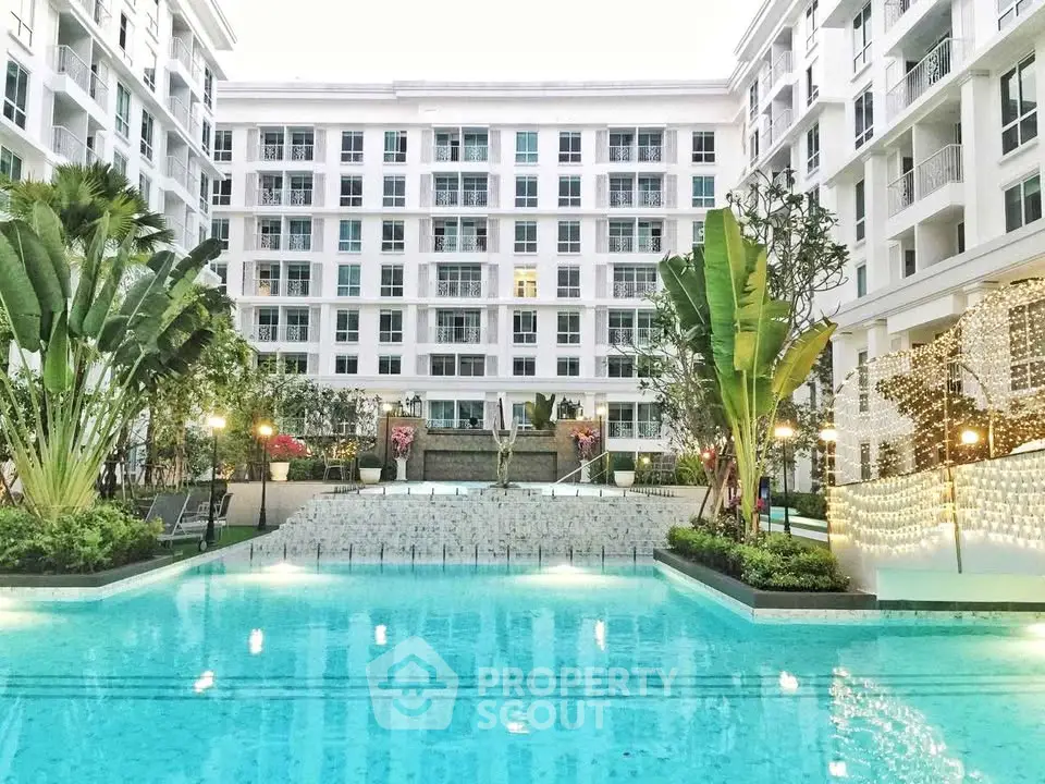 Luxurious apartment complex with stunning pool and lush gardens