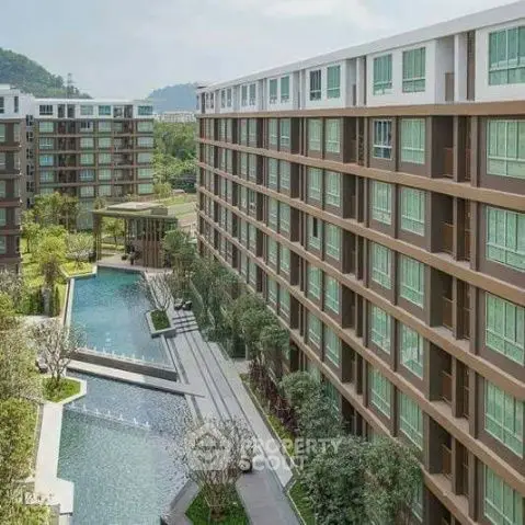 Modern apartment complex with pool and lush landscaping