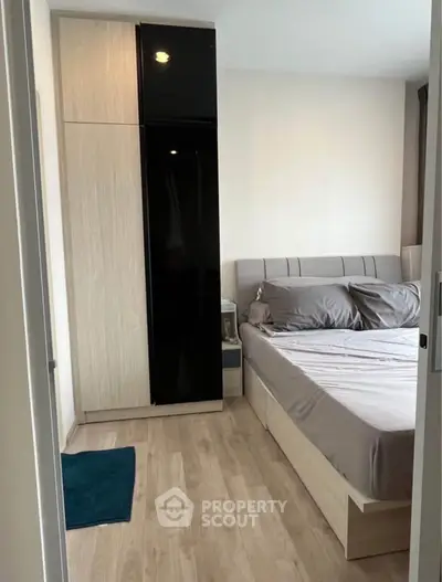 Modern bedroom with sleek wardrobe and cozy bed in stylish apartment.