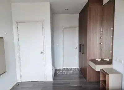 Modern minimalist bedroom with sleek wooden wardrobe and neutral tones