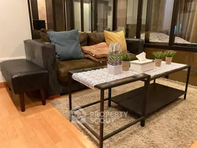 Cozy living room with modern sofa, stylish coffee table, and decorative plants on a plush rug.