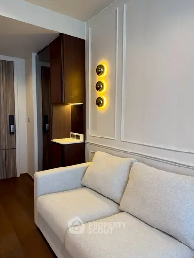Modern living room with stylish lighting and cozy beige sofa in elegant apartment.