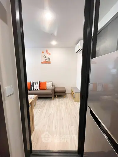 Modern living room with stylish decor and cozy seating area, perfect for relaxation.