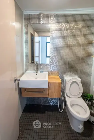 Modern bathroom with stylish mosaic tiles and sleek fixtures