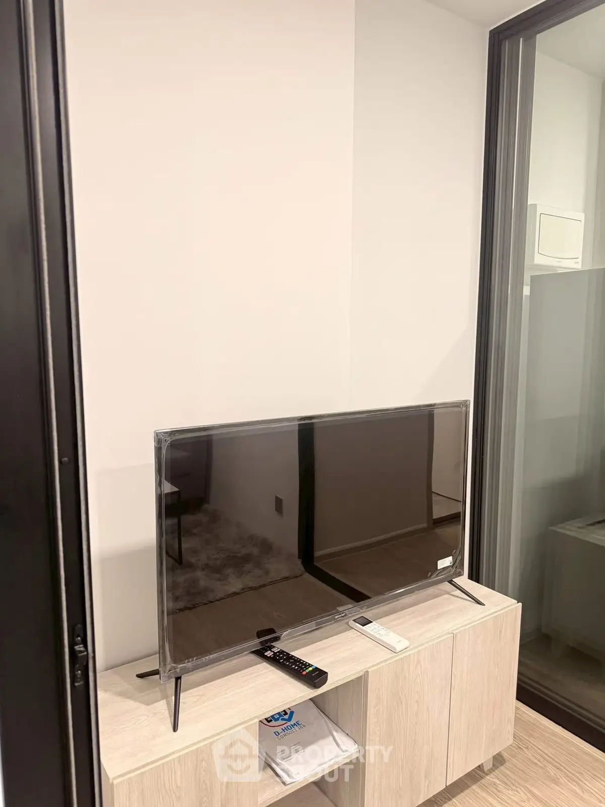 Modern living room with sleek TV setup and stylish wooden cabinet