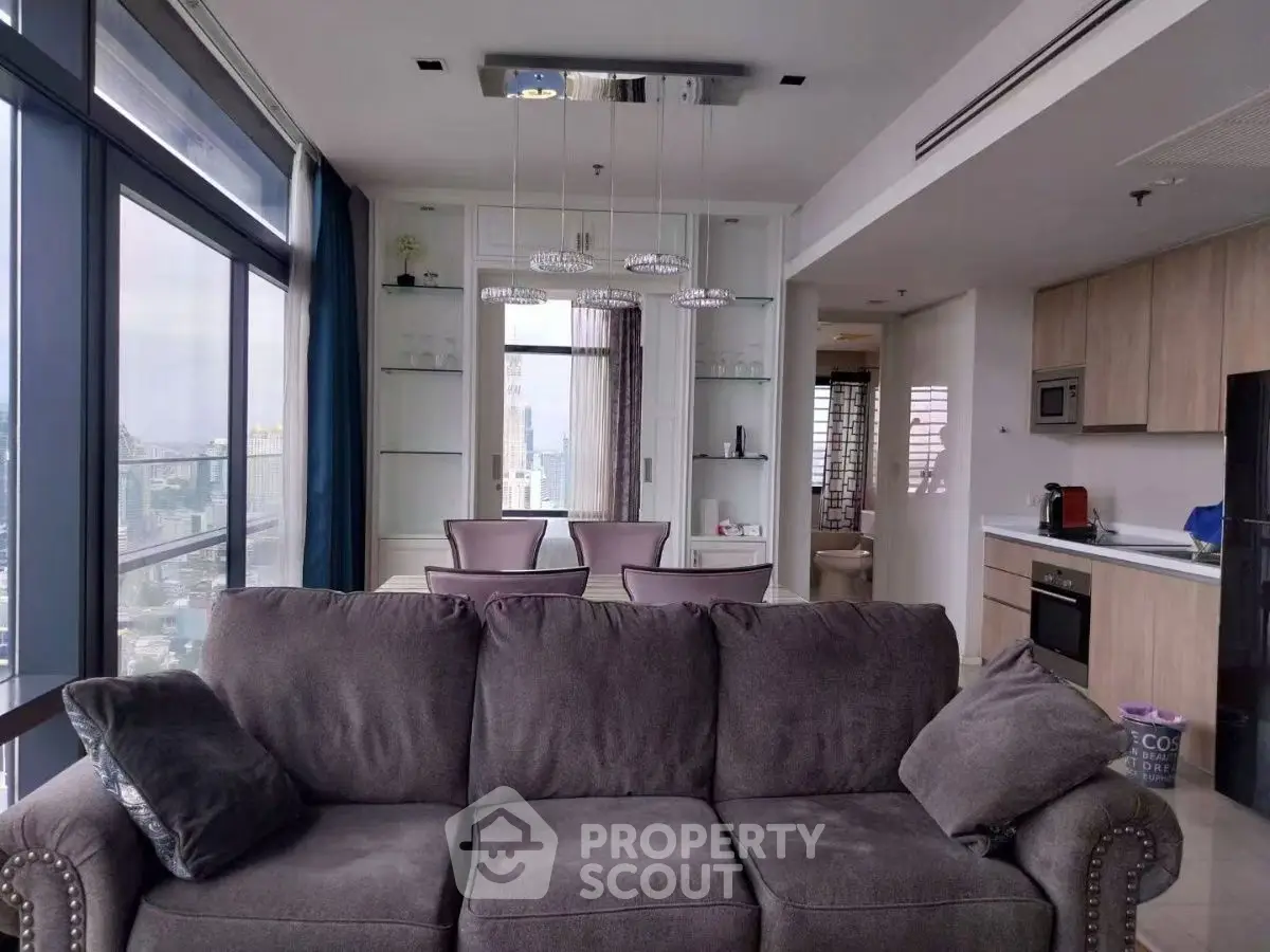 Modern living room with panoramic city view and sleek kitchen design