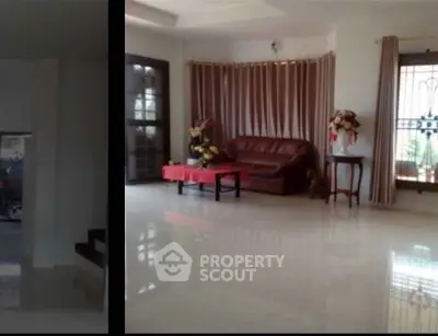 Spacious living room with elegant decor and large windows for natural light.