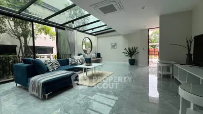Spacious modern living room with glass ceiling and elegant decor