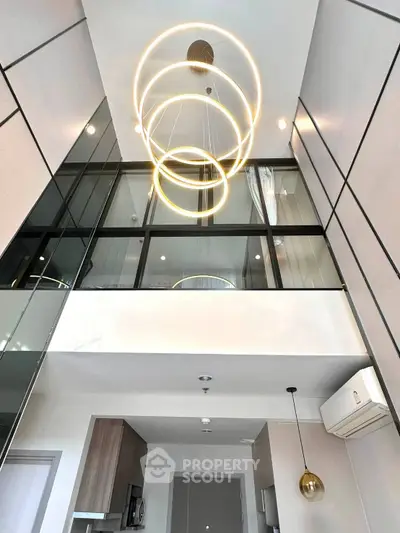 Modern duplex interior with high ceilings and stylish lighting fixture