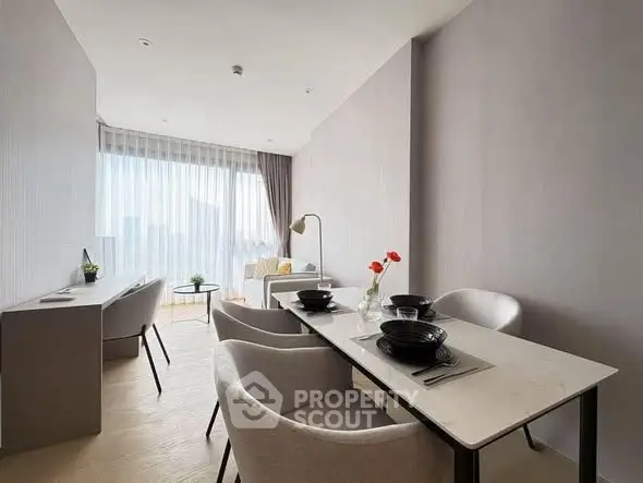 Modern dining area with elegant table setting and natural light in contemporary apartment.
