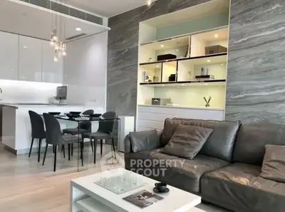 Modern open-plan living room with sleek kitchen and stylish decor