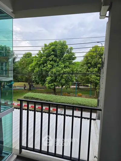 Charming balcony view overlooking lush greenery and serene surroundings.