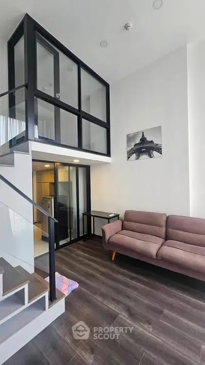 Modern loft-style living room with high ceilings and elegant decor