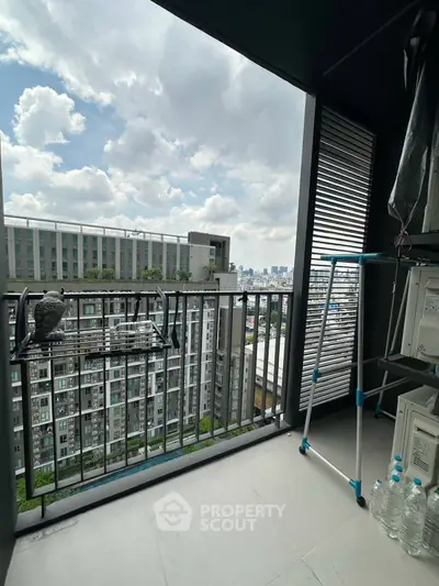 Modern balcony with city view, featuring laundry rack and storage space, ideal for urban living.