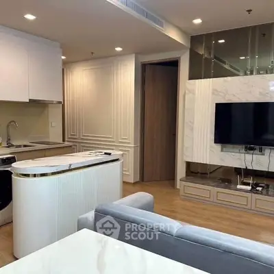 Modern open-plan living room with sleek kitchen and stylish decor