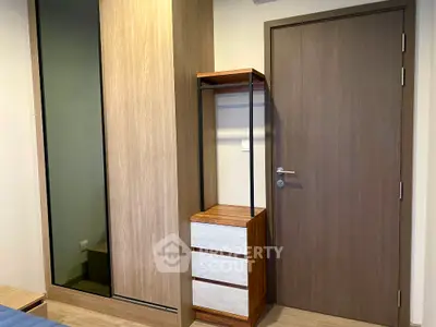 Modern bedroom with sleek wooden wardrobe and stylish storage unit