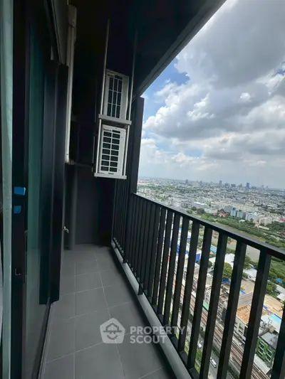 Stunning high-rise balcony with panoramic city views and modern railing design.
