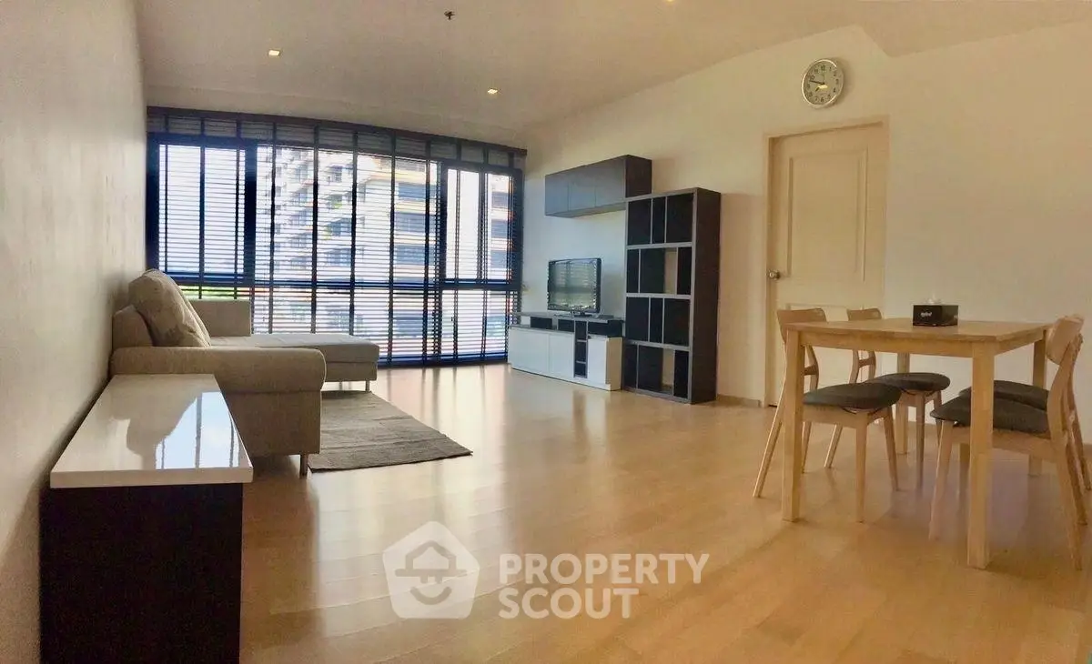 Spacious modern living room with large windows and elegant furniture