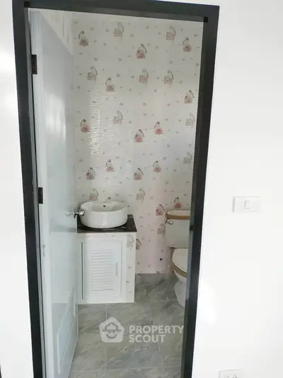 Charming bathroom with floral wallpaper and modern fixtures