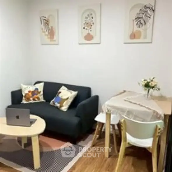 Cozy living room with modern decor and compact dining area