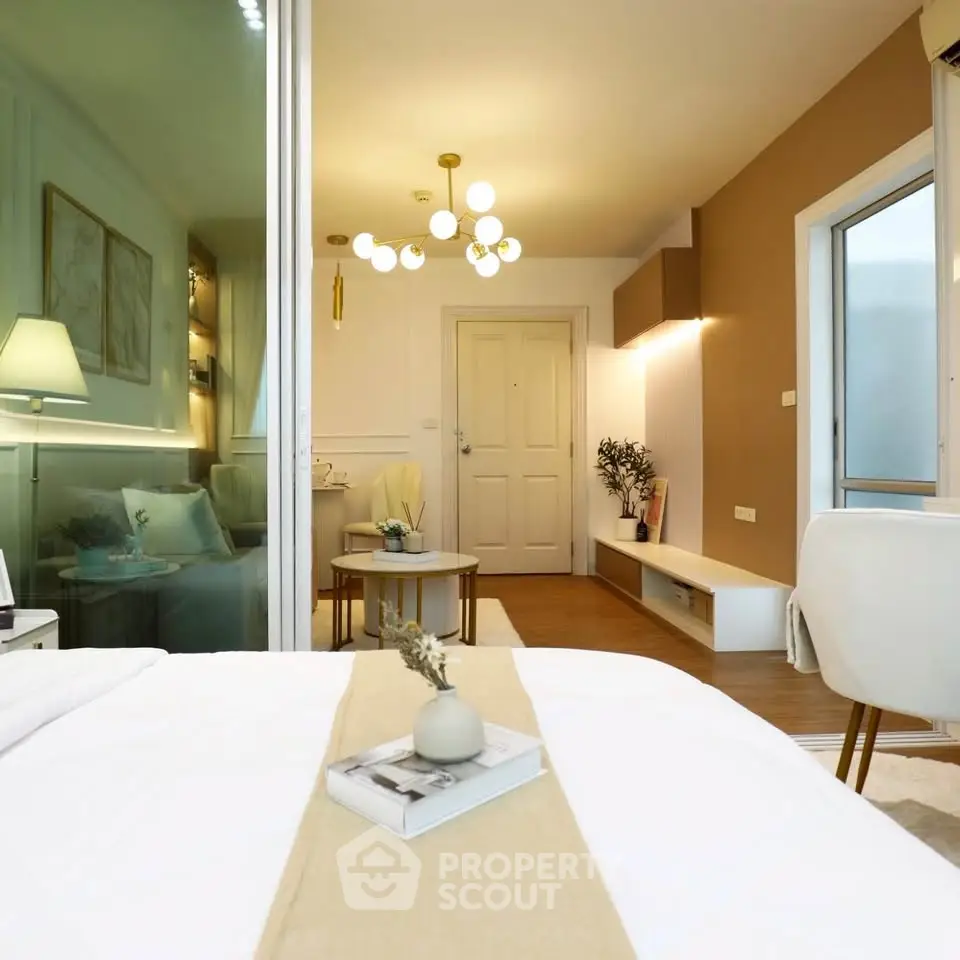Modern bedroom with elegant decor and cozy ambiance, featuring stylish lighting and a neutral color palette.