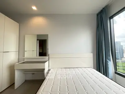 Modern bedroom with large window and city view, featuring sleek furniture and minimalist design.
