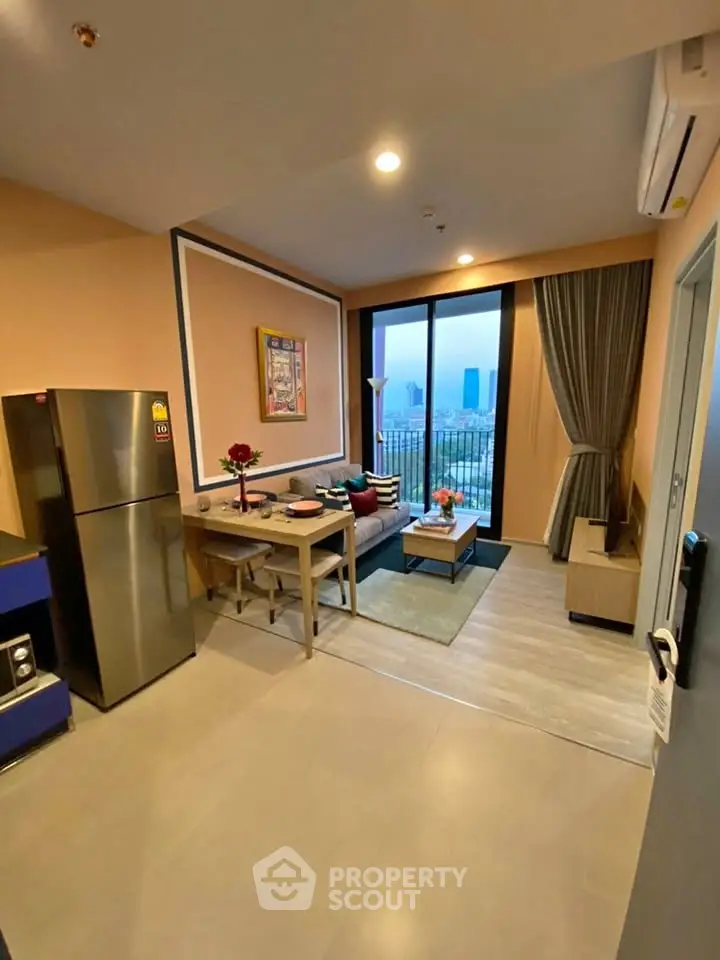 Modern living room with open kitchen and city view, featuring stylish decor and natural light.