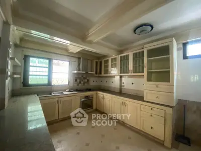 Spacious kitchen with modern cabinetry and built-in oven, perfect for culinary enthusiasts.