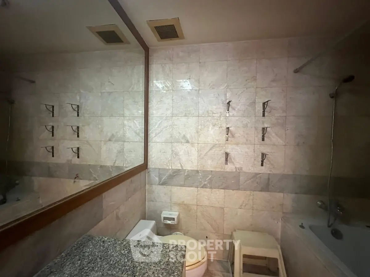 Spacious bathroom with elegant marble tiles and modern fixtures