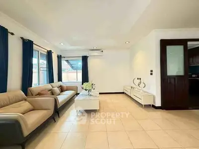 Spacious living room with modern furniture and large windows for natural light.