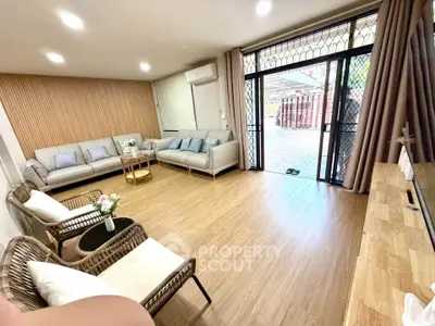 Spacious modern living room with elegant decor and large windows for natural light.