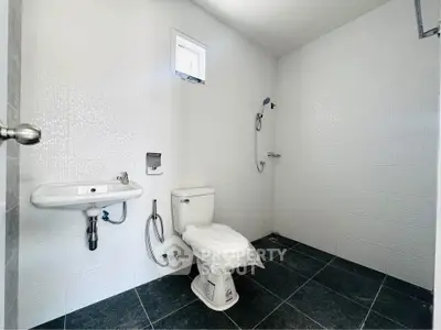 Spacious modern bathroom with sleek fixtures and minimalist design.