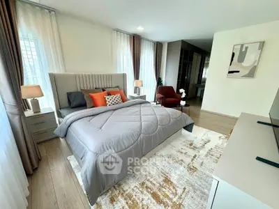 Luxurious bedroom with modern decor, plush bedding, and ample natural light.