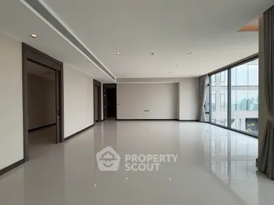 Spacious modern living room with large windows and city view, perfect for urban living.