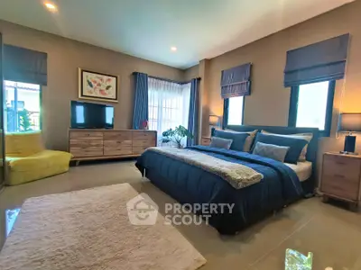 Luxurious bedroom with modern decor and ample natural light