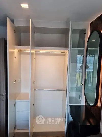 Spacious modern wardrobe with sleek design and ample storage in a stylish interior setting.