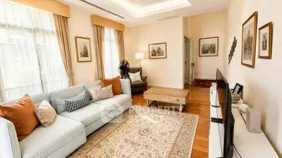 Elegant living room with cozy sofa, stylish decor, and natural light, perfect for relaxation and entertainment.