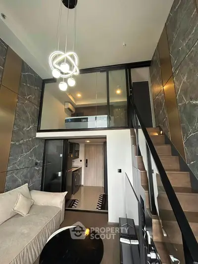 Modern loft apartment with stylish interior, featuring a mezzanine, sleek kitchen, and elegant lighting.