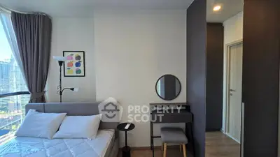 Modern bedroom with stylish decor and city view, featuring a cozy bed and elegant furnishings.