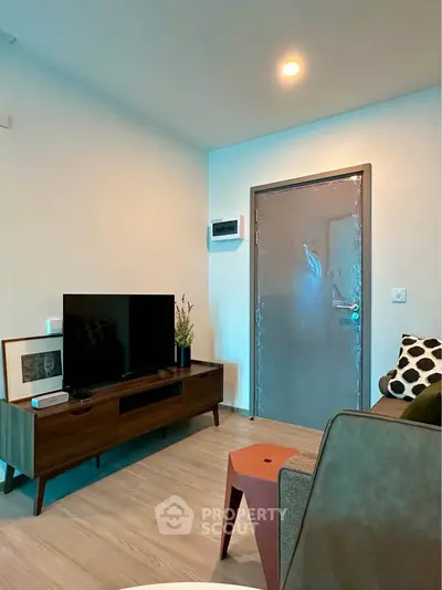 Modern living room with stylish furniture and TV setup, perfect for cozy relaxation.